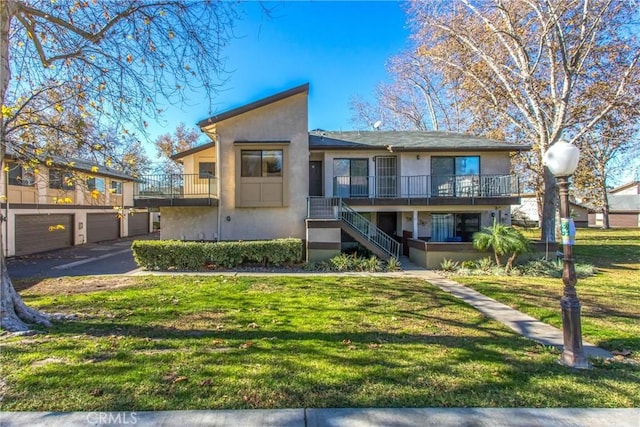 view of front of property with a front lawn and a garage