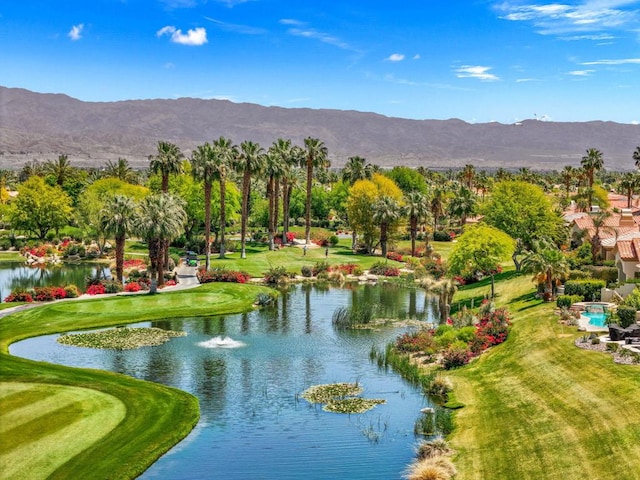 surrounding community featuring a water and mountain view and a yard