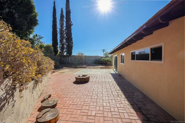 view of patio with a fire pit