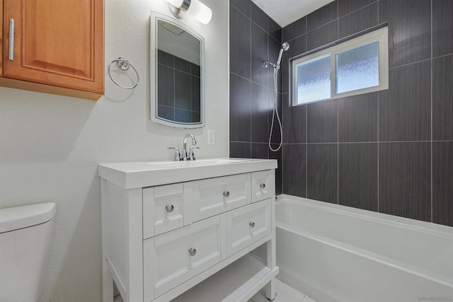 full bathroom featuring toilet, tiled shower / bath combo, and vanity