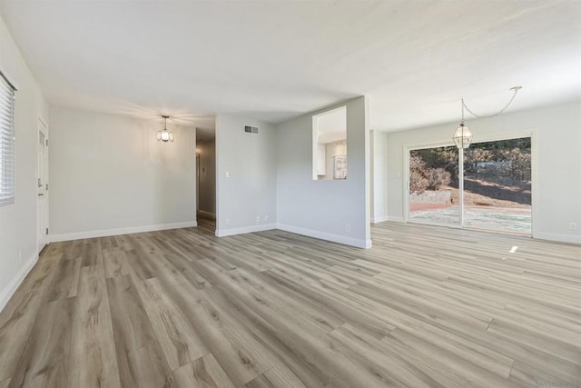 unfurnished living room featuring light wood-type flooring