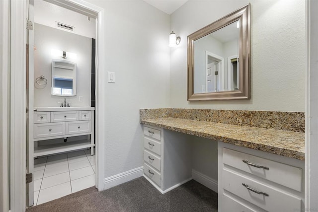 bathroom with tile patterned flooring and vanity