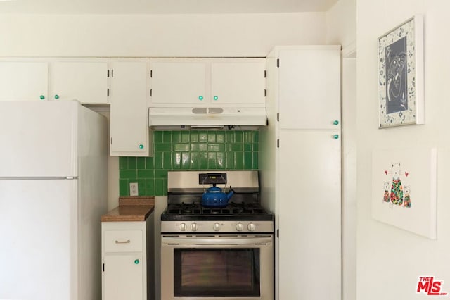 kitchen with gas range, white cabinets, white refrigerator, and decorative backsplash