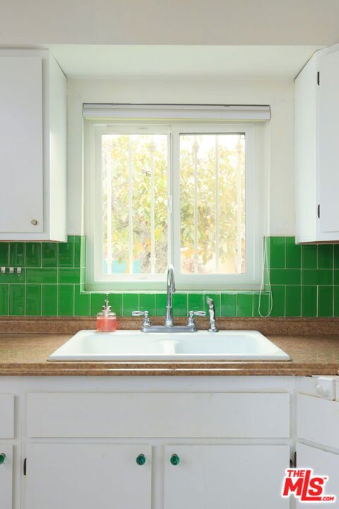 interior details with sink and white cabinetry