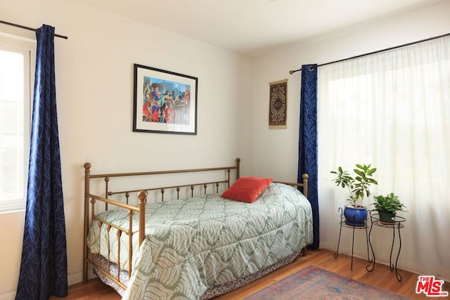 bedroom with hardwood / wood-style flooring