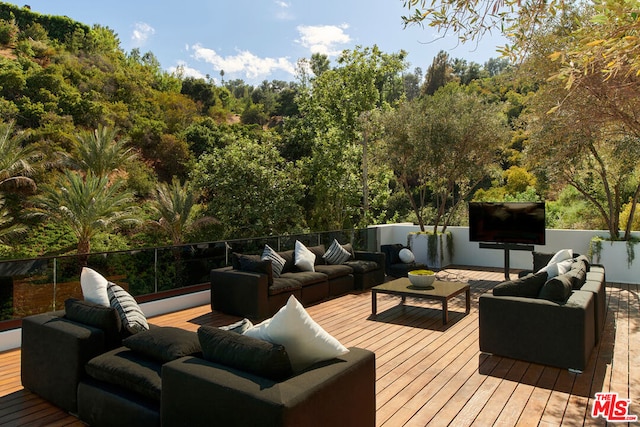 wooden terrace with an outdoor hangout area