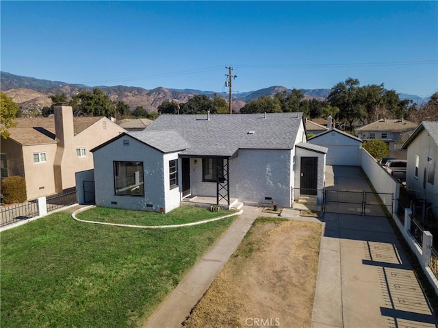 view of front of house with a front yard and a mountain view