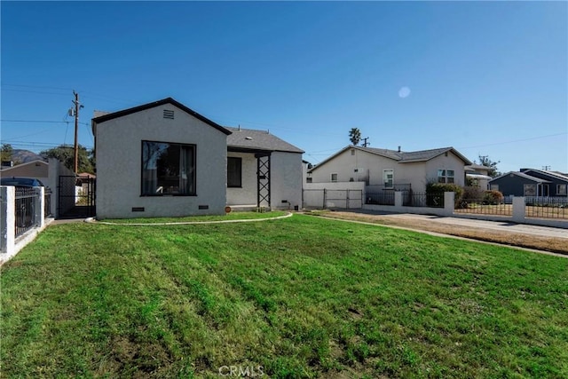 rear view of property featuring a lawn