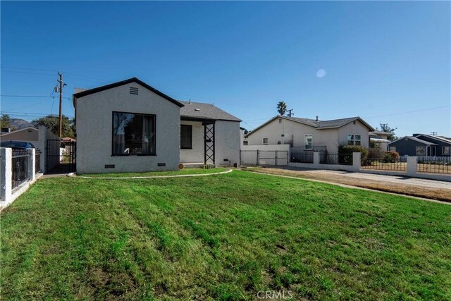 rear view of house with a lawn