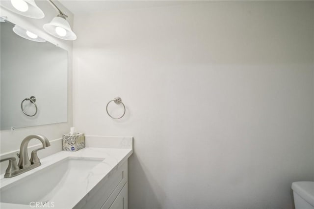 bathroom featuring toilet and vanity