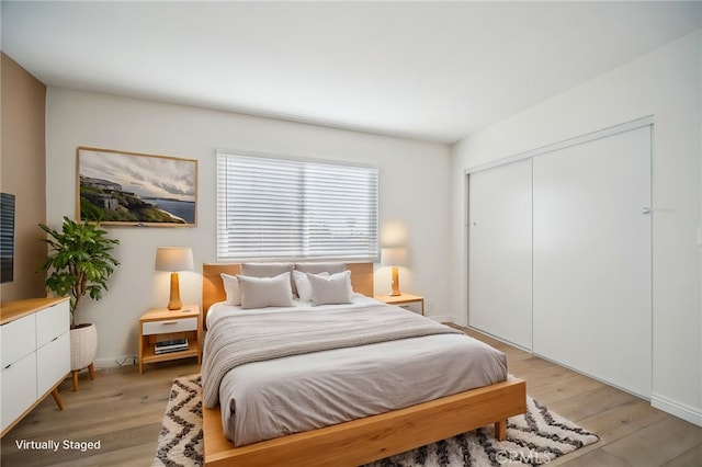 bedroom with a closet and light wood-type flooring