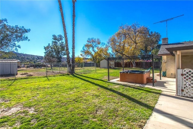 view of yard with a storage unit, a hot tub, and a patio