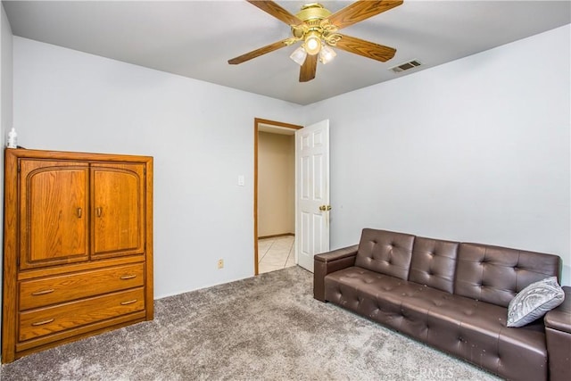 living room with light colored carpet and ceiling fan