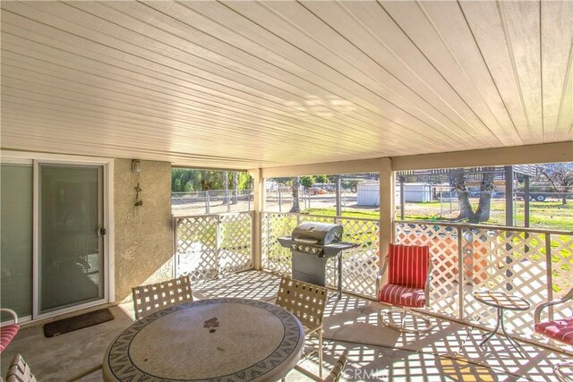 sunroom featuring wood ceiling