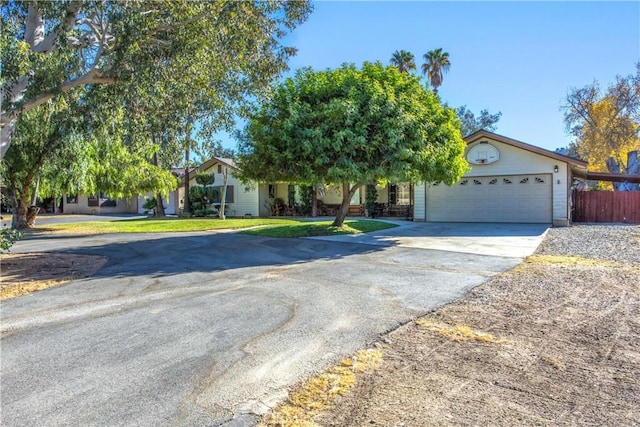 view of property hidden behind natural elements featuring a garage