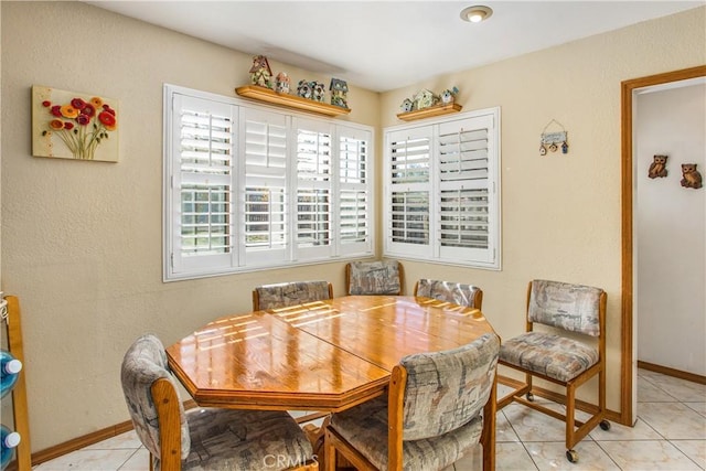 dining space featuring light tile patterned floors