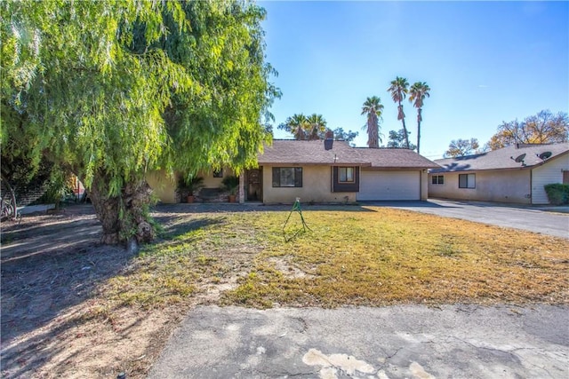 view of front of home with a garage and a front lawn