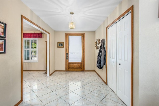 doorway to outside featuring light tile patterned flooring