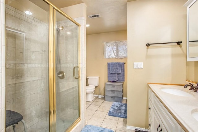 bathroom featuring an enclosed shower, vanity, tile patterned floors, and toilet