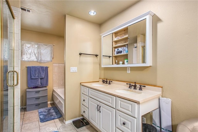 bathroom with vanity, tile patterned flooring, and plus walk in shower