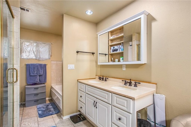 bathroom with tile patterned floors, plus walk in shower, and vanity