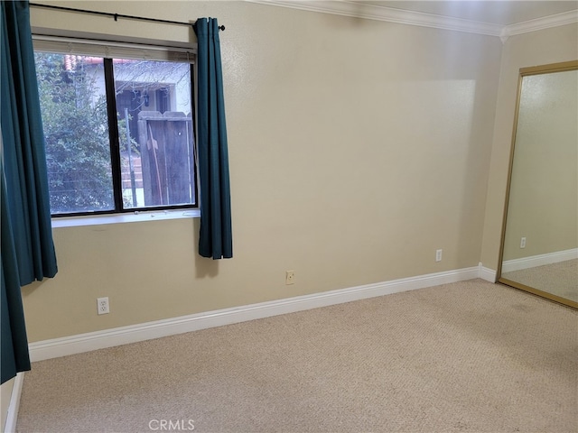 carpeted spare room with a healthy amount of sunlight and ornamental molding