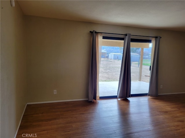 unfurnished room featuring dark wood-type flooring