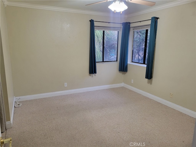 empty room featuring crown molding, carpet floors, and ceiling fan