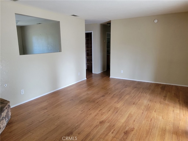 unfurnished room with hardwood / wood-style flooring