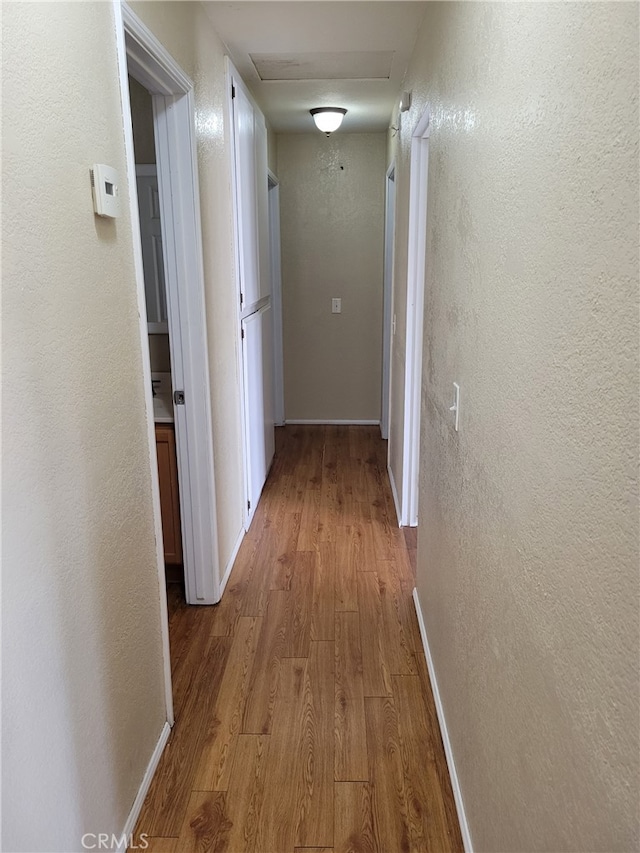 hall with light hardwood / wood-style floors