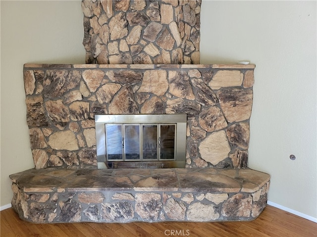 details featuring hardwood / wood-style floors and a fireplace