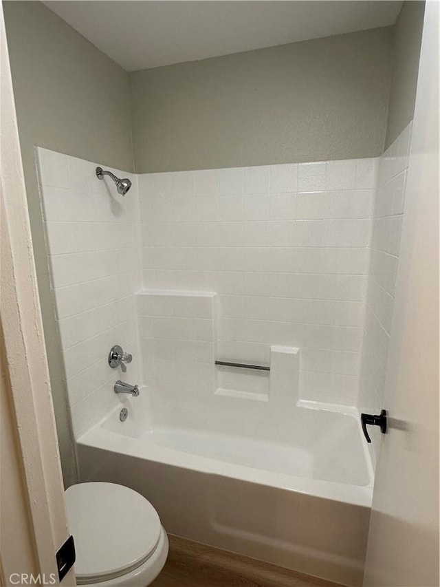 bathroom with toilet, shower / washtub combination, and wood-type flooring