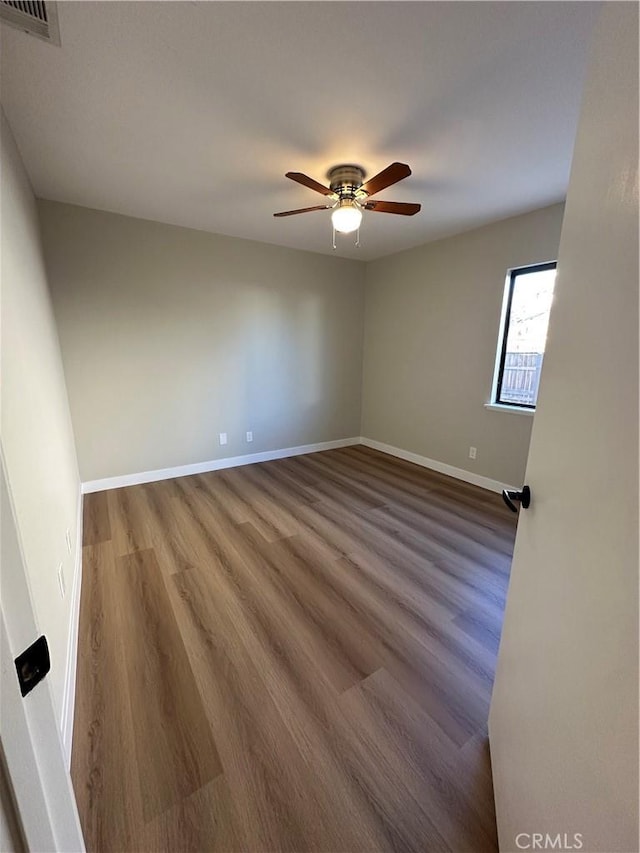 spare room with ceiling fan and hardwood / wood-style flooring