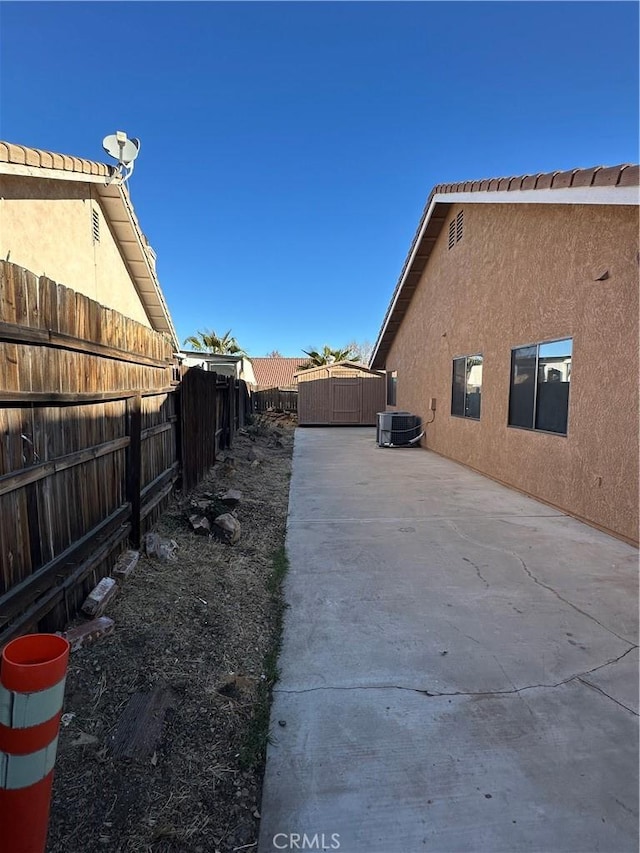 view of side of home featuring a patio and cooling unit