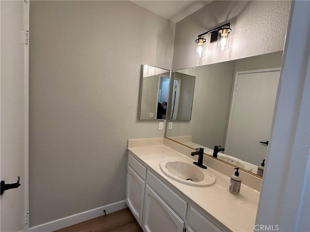 bathroom with wood-type flooring and vanity