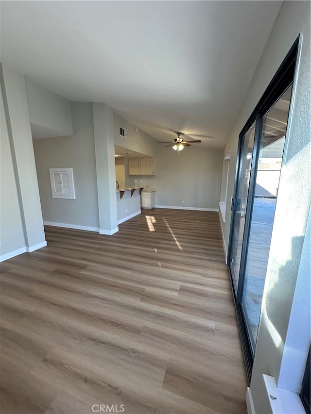 unfurnished living room featuring light wood-type flooring and ceiling fan