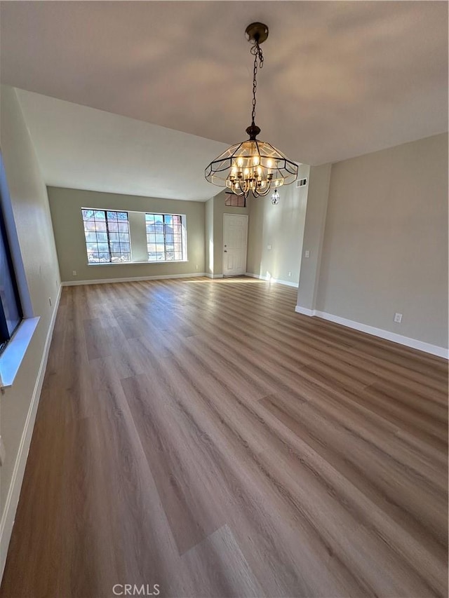 interior space with an inviting chandelier and hardwood / wood-style flooring