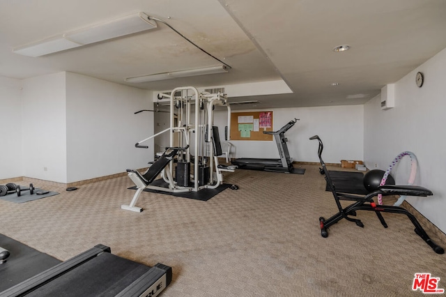 exercise room featuring carpet and a wall mounted AC