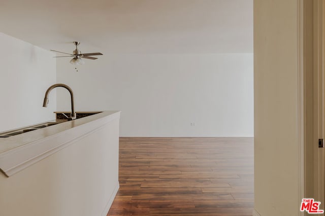 interior space featuring ceiling fan, dark hardwood / wood-style flooring, and sink