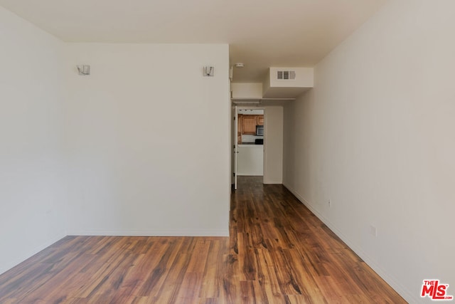 empty room featuring dark wood-type flooring