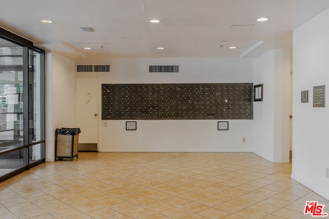 unfurnished room featuring mail boxes