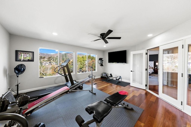 workout area featuring ceiling fan, french doors, and dark hardwood / wood-style floors