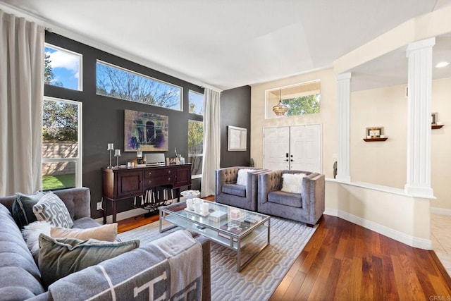 living room featuring hardwood / wood-style flooring and ornate columns