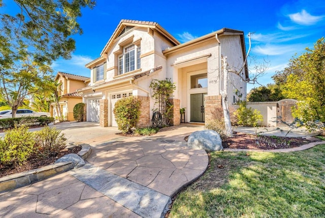 mediterranean / spanish home featuring a garage