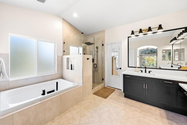 bathroom featuring tile patterned floors, vaulted ceiling, separate shower and tub, and vanity