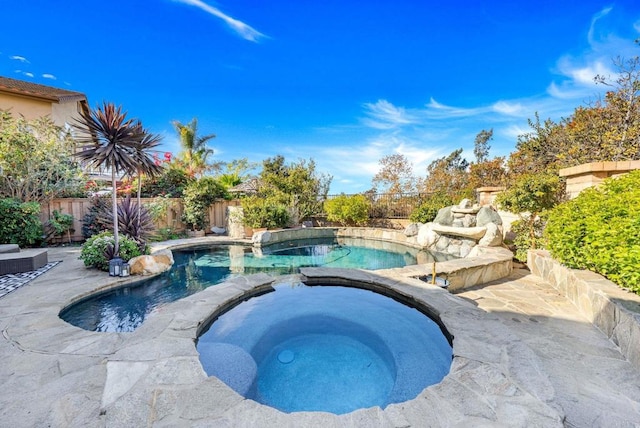 view of pool featuring an in ground hot tub