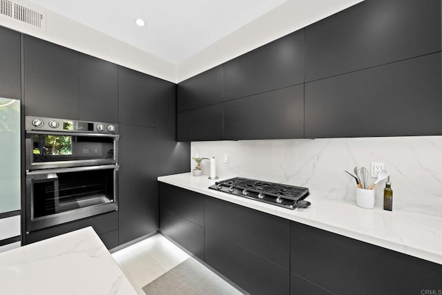 kitchen featuring appliances with stainless steel finishes and decorative backsplash