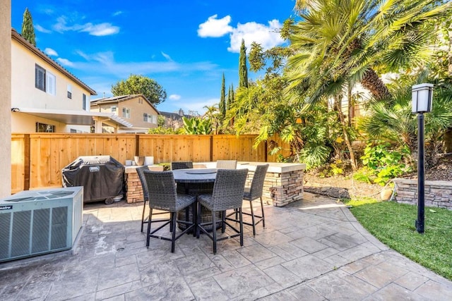 view of patio with a grill and central air condition unit