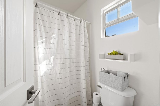 bathroom with toilet and walk in shower