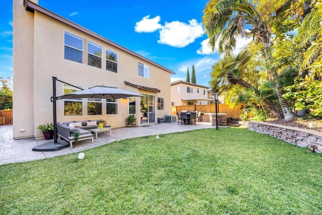 rear view of house featuring central AC, a yard, an outdoor living space, and a patio area